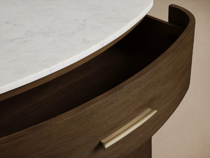 Danny Five-Drawer Dresser: dark oak, curved front, white marble top, brass pulls. Two bottom drawers open, angled.