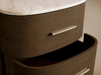 Danny Nightstand: Dark brown oak, rounded front, two drawers with brass pulls, and a light marble top on short legs.