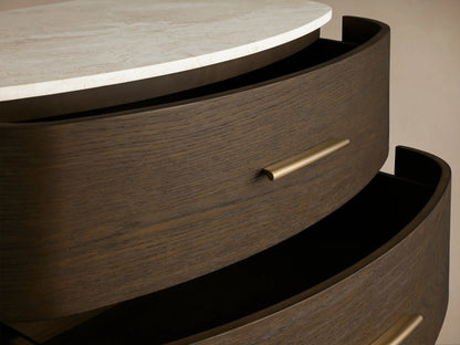 Danny Five-Drawer Dresser: dark oak wood, rounded front, white marble top, five drawers with brass pulls, on tapered legs.