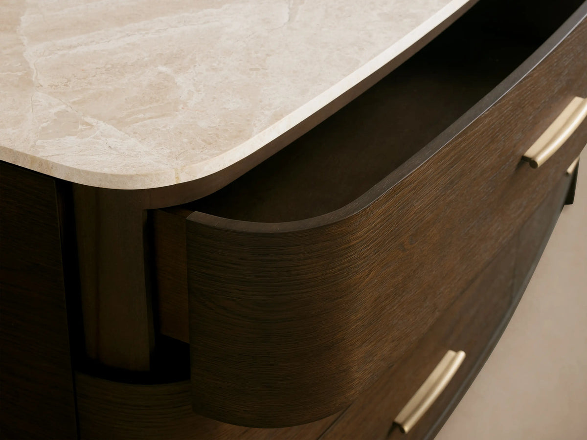 Danny Six-Drawer Dresser with dark oak finish, white marble top, six drawers, brass pulls, and rounded edges.