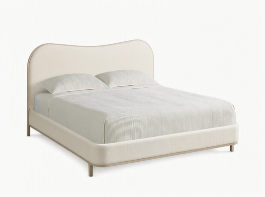 Danny Camelback Bed with a light beige upholstered camelback headboard & low frame, light grey legs. Striped bedding.