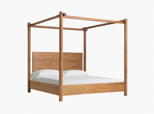 Dutton Canopy Bed, light brown acacia wood frame with matching headboard, white bedding. Set in a room with beige wall, wood floor.