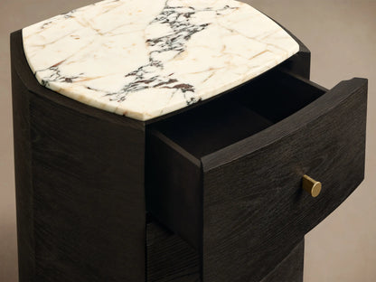 Front view of the dark brown Elton Nightstand, featuring three drawers with satin brass knobs and a white marble top with grey veining.