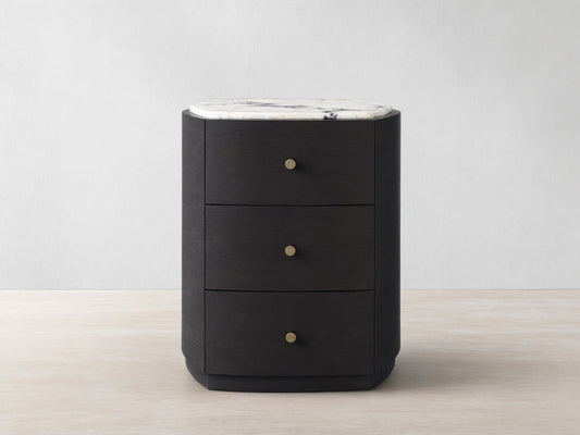 Front view of the dark brown Elton Nightstand, featuring three drawers with satin brass knobs and a white marble top with grey veining.