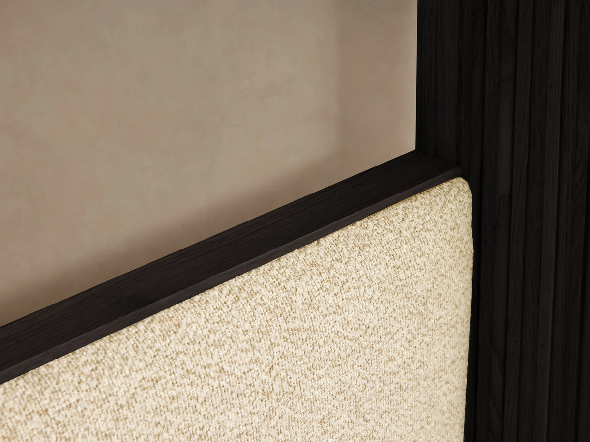 Front view of an Ebony Finnley Canopy Bed™ with reeding detailing, light beige upholstered headboard, and white bedding with a brown throw.