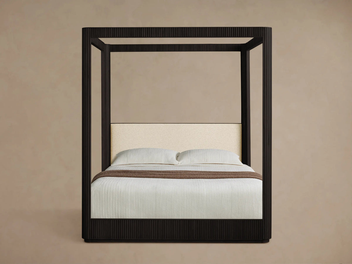 Close-up of the Adilon Latte Performance fabric upholstered headboard and Ebony reeded wood detail on the Finnley Canopy Bed.