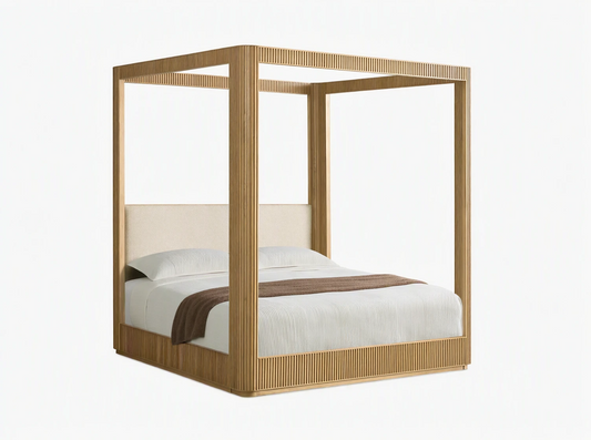 Front view of the Finnley Canopy Bed, featuring a light natural wood frame with reeded details and a cream upholstered headboard.