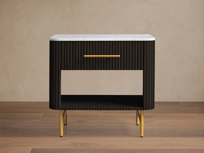 Finnley Open Nightstand with a marble top, brass-finished handle, dark ribbed body, open shelf, and brass legs on a wooden floor.