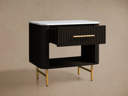Finnley Open Nightstand with a marble top, brass-finished handle, dark ribbed body, open shelf, and brass legs on a wooden floor.