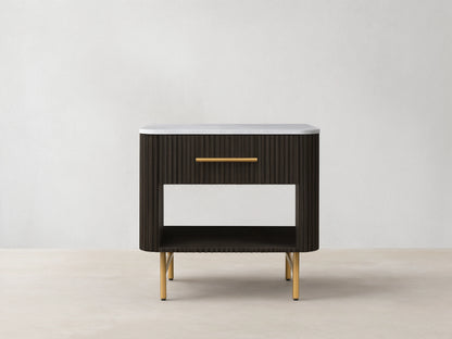 Finnley Open Nightstand with a marble top, brass-finished handle, dark ribbed body, open shelf, and brass legs on a wooden floor.