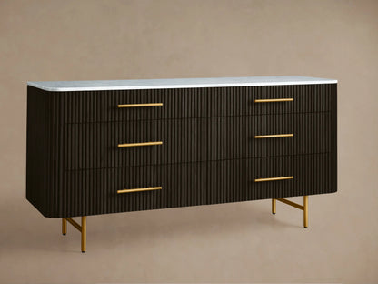 Finnley Six-Drawer Dresser in ebony with reeded drawers, white marble top, gold pulls, and slender gold legs, front view.