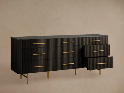Finnley Nine-Drawer Dresser in dark wood finish with ribbed texture, featuring nine drawers and brass-finished handles, set on gold legs.
