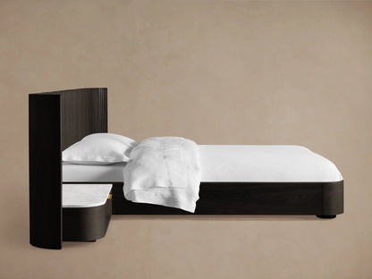 Top-down view of the Finnley Extended Headboard Bed showing a curved, grooved dark wood finish with a smooth white marble top and an open drawer with brass hardware.