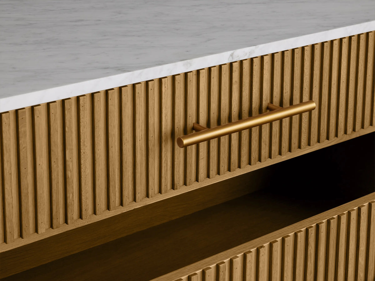 Finnley Five-Drawer Dresser: honey oak reeded front, white stone top, 5 brass bar handles, angled brass legs.