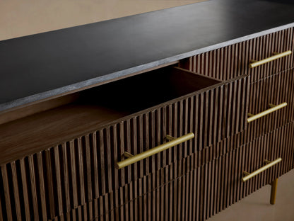 Finnley Six-Drawer Dresser in dark wood with vertical grooves, brass handles, top two drawers slightly open, and slender legs.