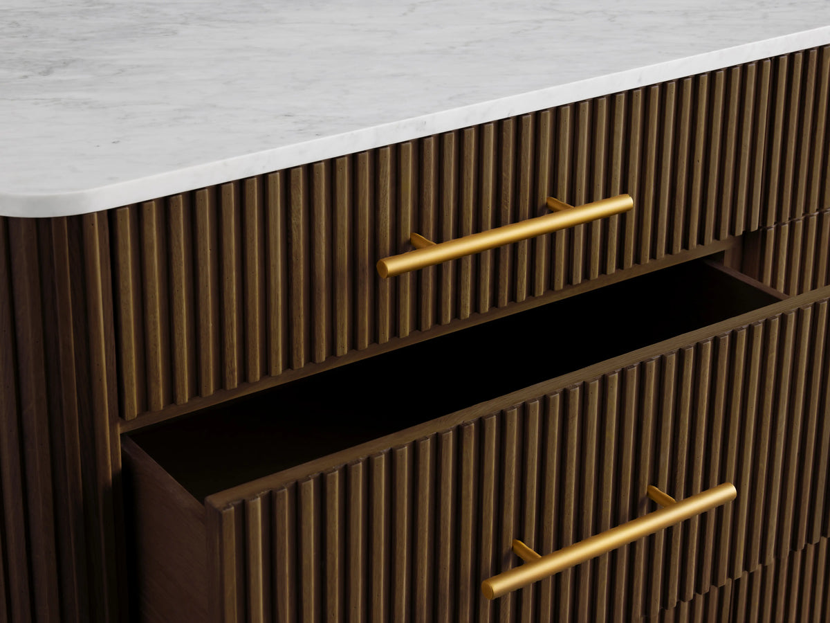 Finnley Nine-Drawer Dresser in dark wood with vertical grooves, brass-finished handles, and white marble top; two drawers open.