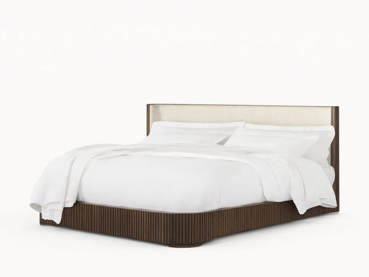 Front view of the Finnley Bed with a dark brown reeded frame and light beige upholstered headboard, topped with white bedding.