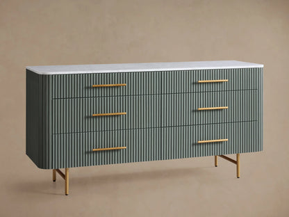 Finnley Six-Drawer Dresser: Sage green dresser with reeded drawers, white stone top, and brass hardware, on wood floor.