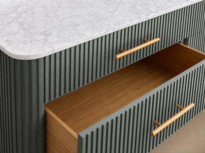 Finnley Six-Drawer Dresser with green reeding detail, white marble top, brass bar handles, and gold angled legs.