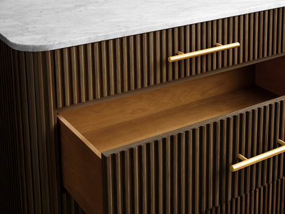 Finnley Five-Drawer Dresser with vertical grooves, brass-finished handles, two open drawers, and a marble top on slender legs.