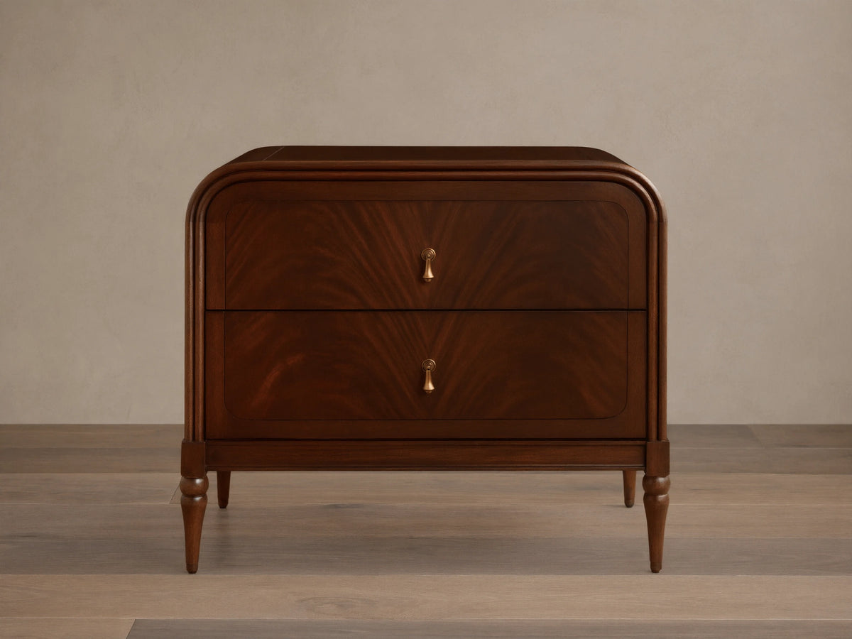 Frances Nightstand, dark brown figured mahogany wood with rounded corners, two drawers, and vintage brass hardware.