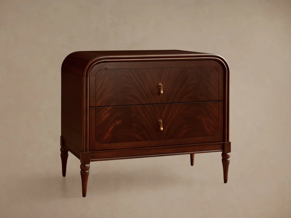 Frances Nightstand, dark brown figured mahogany wood with rounded corners, two drawers, and vintage brass hardware.