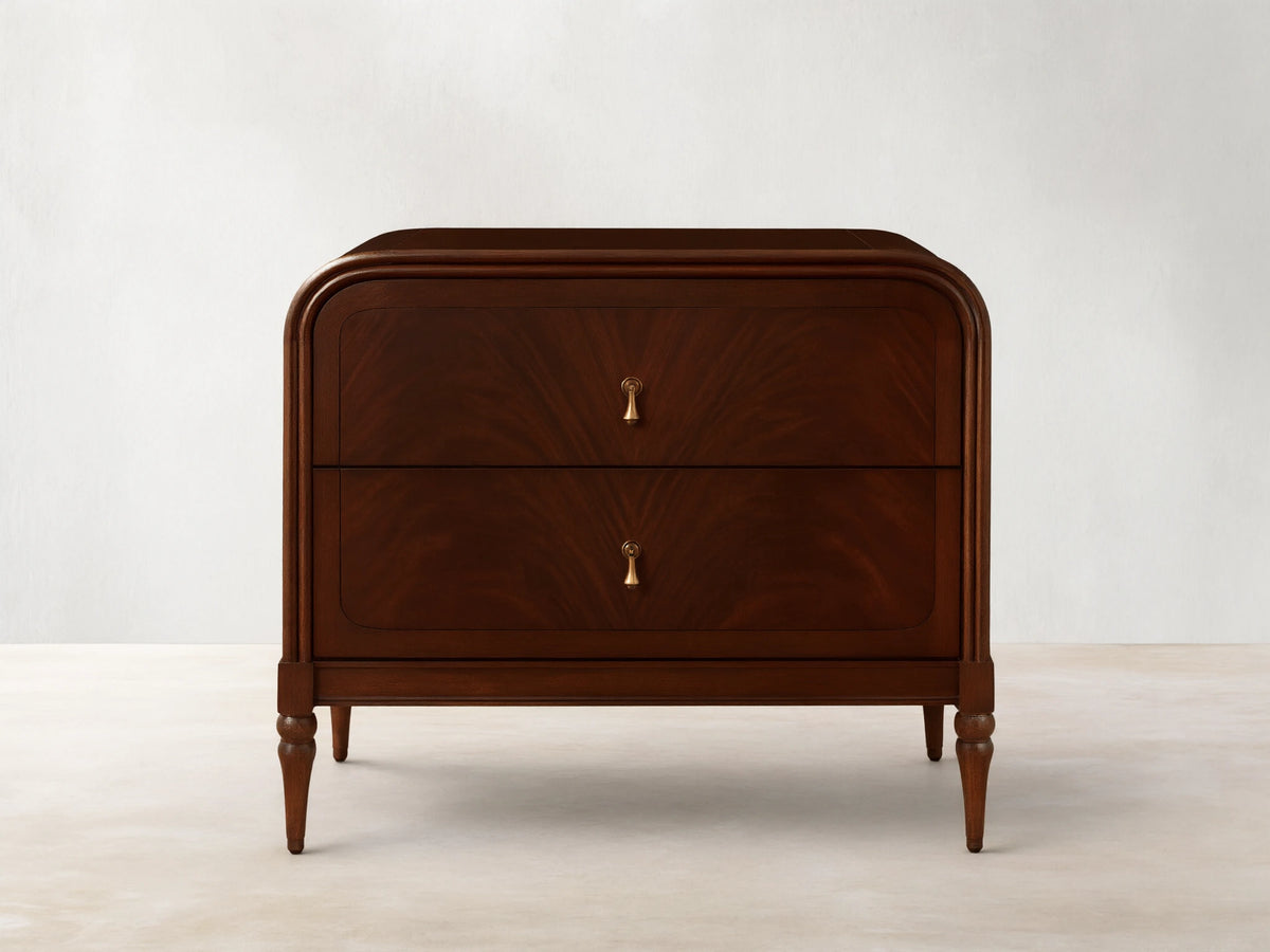 Frances Nightstand, dark brown figured mahogany wood with rounded corners, two drawers, and vintage brass hardware.