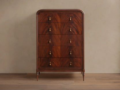 Frances Five-Drawer Dresser: Dark mahogany wood, rounded top, 5 stacked drawers, 10 brass pulls, on wooden floor.