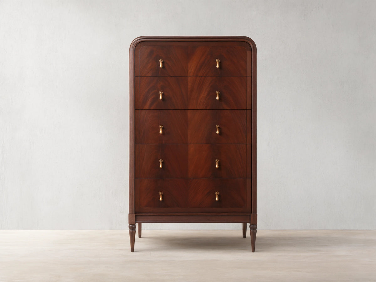 Frances Five-Drawer Dresser: Dark mahogany wood, rounded top, 5 stacked drawers, 10 brass pulls, on wooden floor.