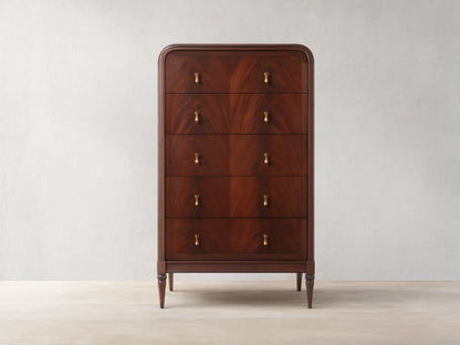 Frances Five-Drawer Dresser: Dark mahogany wood, rounded top, 5 stacked drawers, 10 brass pulls, on wooden floor.