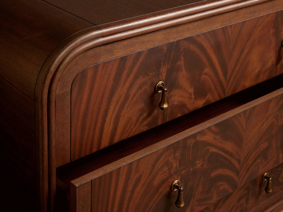 Frances Six-Drawer Dresser: Dark mahogany wood with flame-like grain, 6 drawers, brass knobs, rounded top, tapered legs.