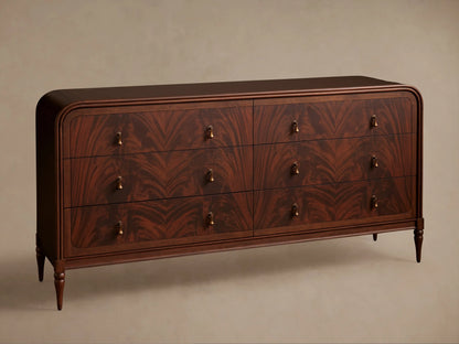 Close-up of Frances Dresser: dark mahogany with curved edges, dramatic figured flame grain. Vintage brass pull, one drawer slightly open.