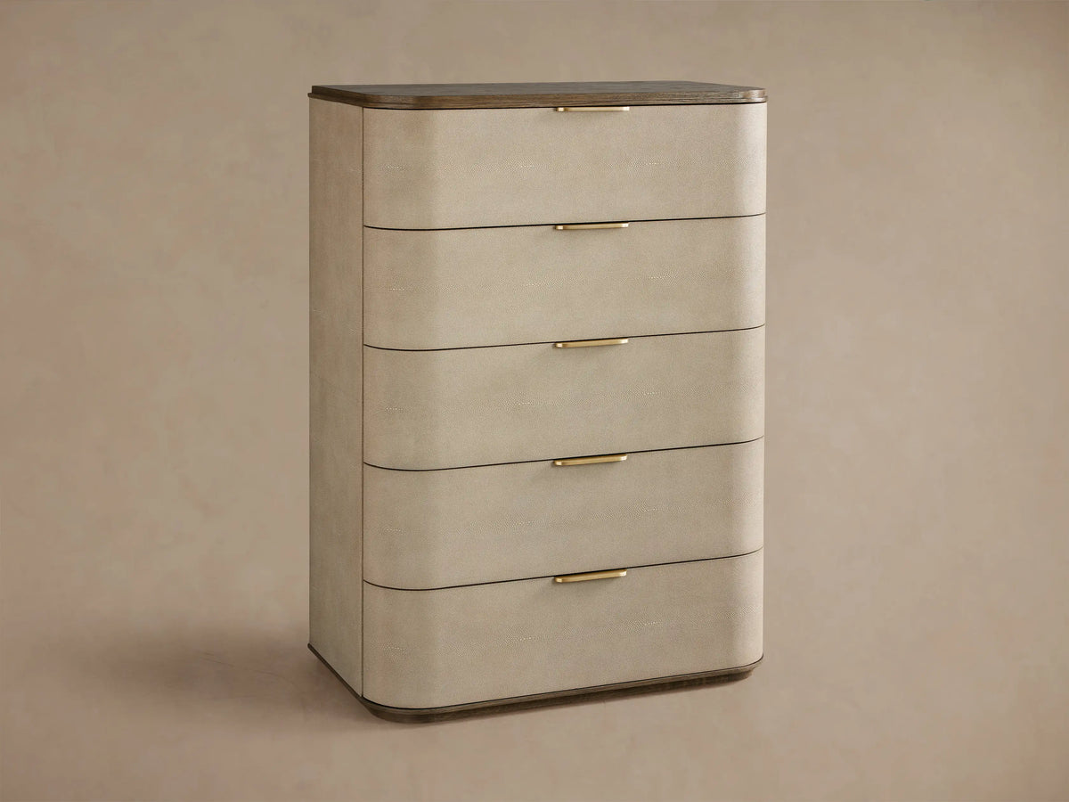 Harrow Five-Drawer Dresser with rounded, light beige faux shagreen drawers, dark wood top, and brass hardware.