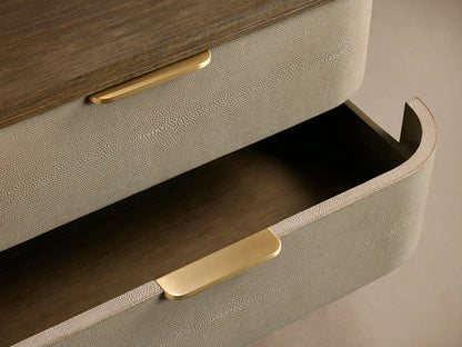 Full-view of Harrow Six-Drawer Dresser with rounded edges, light beige faux shagreen drawers, dark wood top & brass pulls.