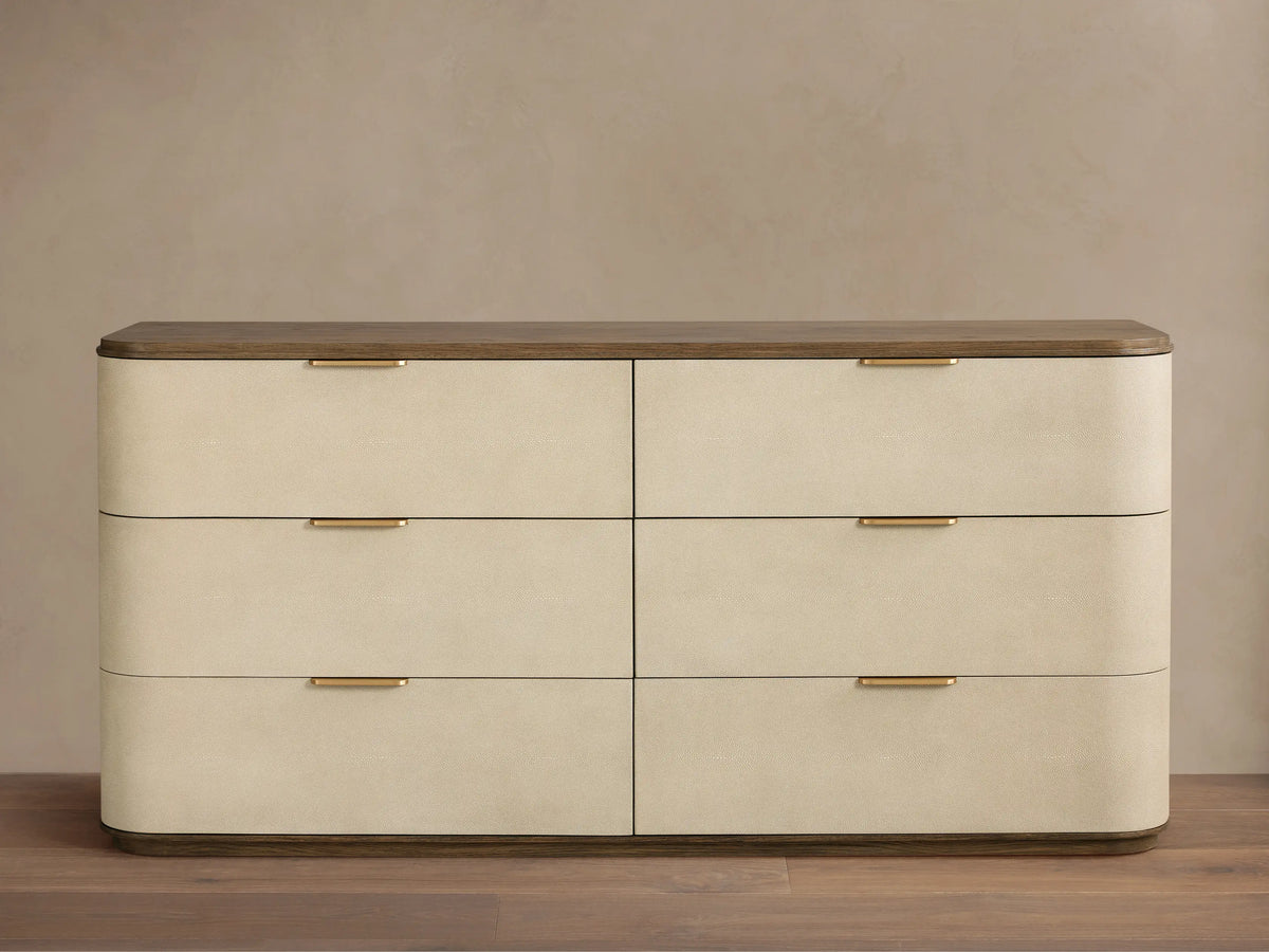 Harrow Six-Drawer Dresser with light grey faux shagreen finish, natural wood top, and six champagne-brass pull handles.