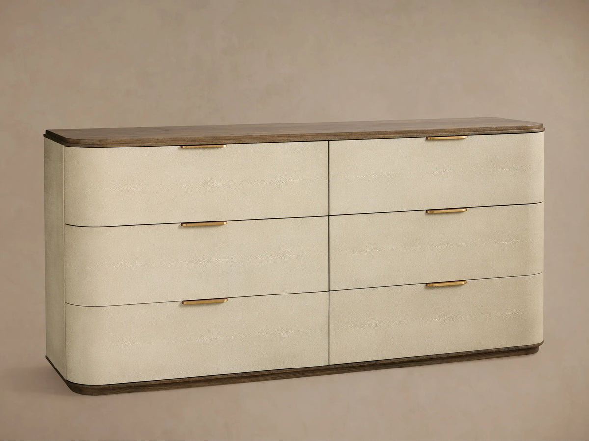 Harrow Six-Drawer Dresser: Light beige faux shagreen dresser with 6 drawers, rounded corners, gold hardware, dark wood top and base.