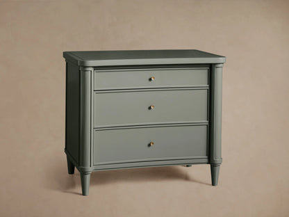 Henley Nightstand in gray with three drawers, featuring petite brass pulls, and a smooth lacquer finish.