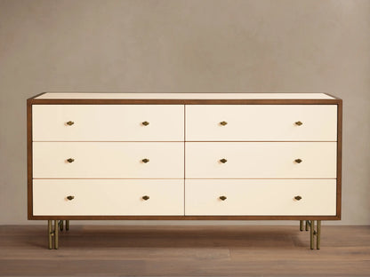 Henton Six-Drawer Dresser with cream drawers, dark wood frame, brass knobs, and brass-finished tubular legs.