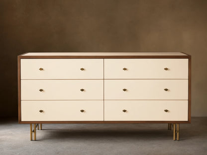 Henton Six-Drawer Dresser with cream drawers, dark wood frame, brass knobs, and brass-finished tubular legs.