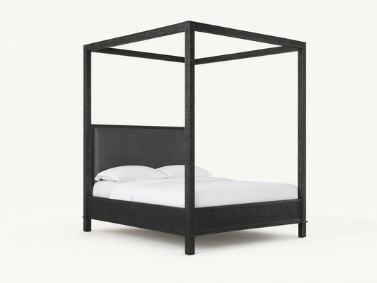 Keene Canopy Bed: Dark brown wooden frame with intricate patterns, brown leather headboard, and white bedding on wood floor.