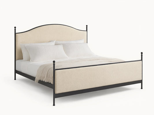 Front view of the Kimber Upholstered Bed with cream upholstered panels, matte black iron frame, and finial details. White bedding.