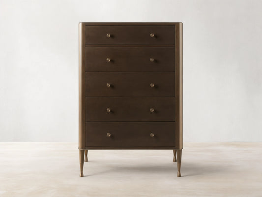 Laurent Five-Drawer Dresser made of dark mahogany and cherry veneers, features patinaed brass feet and knobs, in a neutral setting.