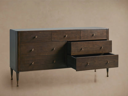 Laurent Seven-Drawer Dresser in dark wood finish, featuring three slightly open drawers, patinaed brass feet, and hardware.