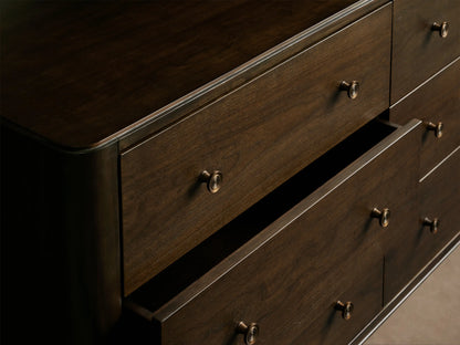 Laurent Nine-Drawer Dresser in dark mahogany finish with rounded corners, nine drawers, and patinaed brass hardware and feet.