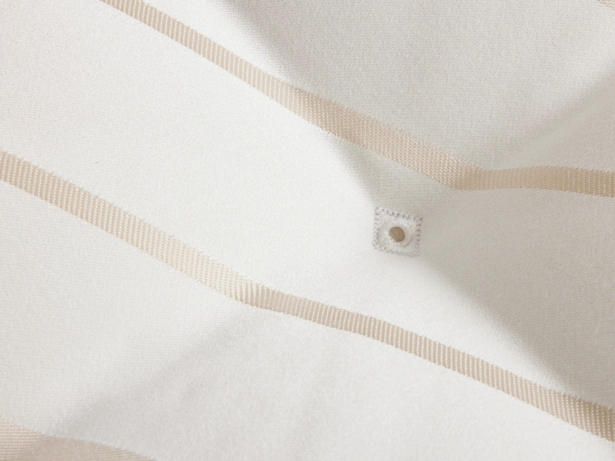 Luxury Firm Mattress featuring a close-up view of a white surface with subtle tan geometric patterns and a tufted design.