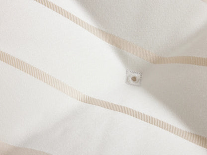 Luxury Plush Mattress with white fabric featuring a subtle geometric pattern. The surface is tufted, creating a quilted effect.