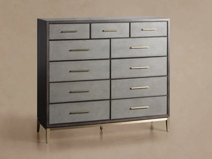 Malone Eleven-Drawer Dresser. Dark wood frame, light grey shagreen-textured drawers with gold handles, and brass base.