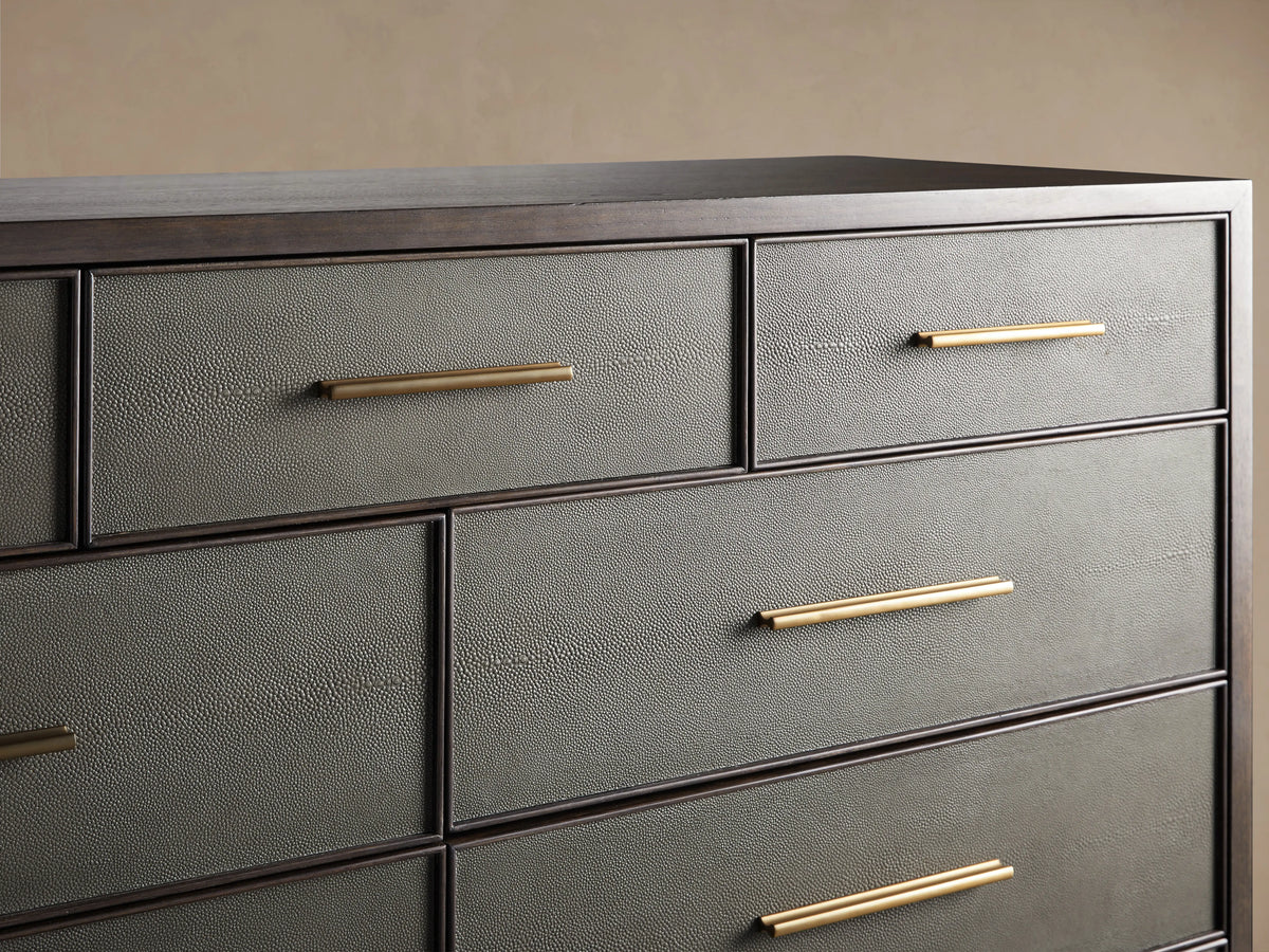 Close-up of Malone Eleven-Drawer Dresser. Open dark gray shagreen drawer with golden handle reveals dark wood interior.