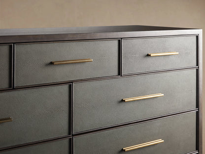 Close-up of Malone Eleven-Drawer Dresser. Open dark gray shagreen drawer with golden handle reveals dark wood interior.