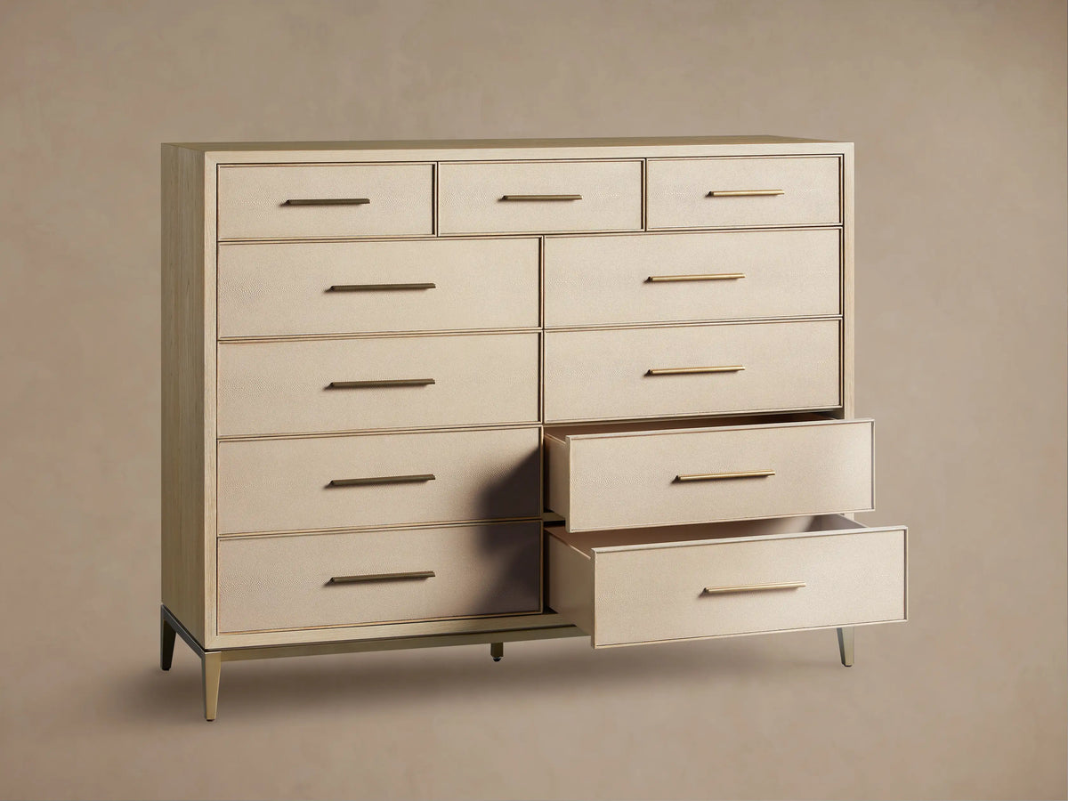Front view of the Bone Malone Eleven-Drawer Dresser with shagreen detailing, gold handles, and two bottom drawers partially open.